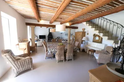 a living room with a dining room table and chairs at magnificient property with heated swimming-pool in the luberon - 14 persons in Les Taillades