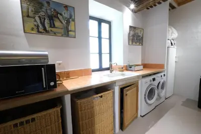 a kitchen with a sink and a washing machine at magnificient property with heated swimming-pool in the luberon - 14 persons in Les Taillades