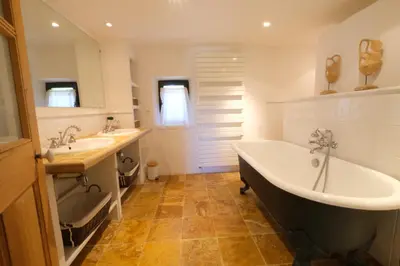 a bathroom with a tub and two sinks and a bath tub at magnificient property with heated swimming-pool in the luberon - 14 persons in Les Taillades