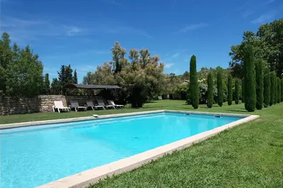 a swimming pool in a yard with trees at magnificient property with heated swimming-pool in the luberon - 14 persons in Les Taillades