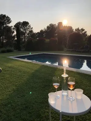 two glasses of wine on a table next to a pool at Lou Pantai, Bed and Breakfast, Delux Bedroom with AC in Aix-en-Provence