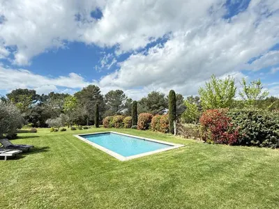 a swimming pool in the middle of a yard at Lou Pantai, Bed and Breakfast, Delux Bedroom with AC in Aix-en-Provence