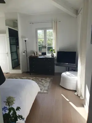 a bedroom with a bed and a desk and a television at Lou Pantai, Bed and Breakfast, Delux Bedroom with AC in Aix-en-Provence
