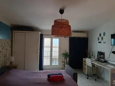 a bedroom with a bed and a desk and a table at Studio cathédrale centre Aix-en-Provence in Aix-en-Provence