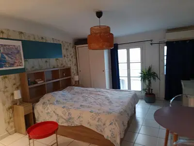 a bedroom with a bed and a table and chairs at Studio cathédrale centre Aix-en-Provence in Aix-en-Provence