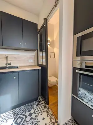 a kitchen with a sink and a stove top oven at UNE TERRASSE SUR LES TOITS in Aix-en-Provence