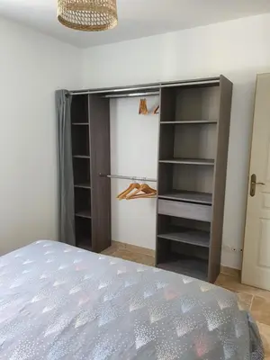 a bedroom with a bed and a closet at Petite maison en campagne in Pernes-les-Fontaines