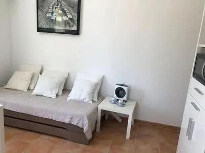 a bedroom with a bed and a small table at Appartement dans bastide à Saint Rémy de Provence in Saint-Rémy-de-Provence