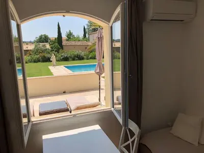 a kitchen with a sliding glass door to a patio at Appartement dans bastide à Saint Rémy de Provence in Saint-Rémy-de-Provence