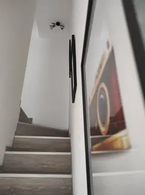 a flight of stairs with a butterfly on the wall at Maison de village avec exterieur in Lambesc