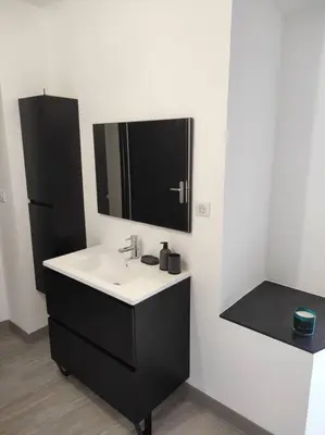 a bathroom with a sink and a mirror at Maison de village avec exterieur in Lambesc
