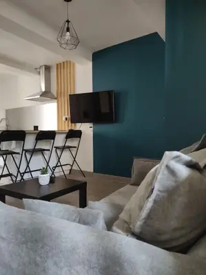a living room with a couch and a table with chairs at Maison de village avec exterieur in Lambesc