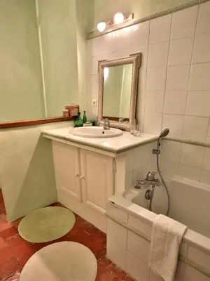 a bathroom with a sink and a tub and a mirror at Domaine la Carraire in Lauris