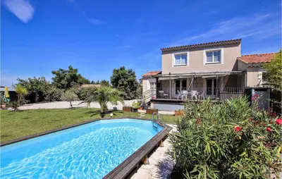 a house with a swimming pool in front of a yard at Gorgeous Home In Aubignan in Aubignan
