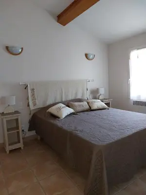 a bedroom with a bed with two pillows on it at En Provence, Chez Stéphanie et Marcel in Saint-Rémy-de-Provence