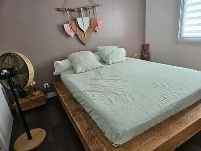 a bedroom with a large bed with a fan at Villa Provence Baraka centre-ville in Salon-de-Provence