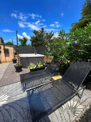 a patio with a table and some plants on it at La pause en luberon in Cavaillon