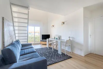 a living room with a blue couch and a table at Charmant T3 proche centre ville avec parking in Aix-en-Provence