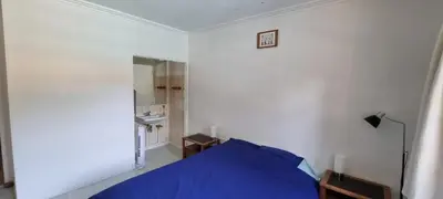 a bedroom with a blue bed in a white room at Chambre d'hôte BB proche d'Aix en Provence in Éguilles