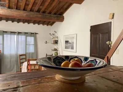 a bowl of fruit sitting on top of a table at Le Cardinale - Un Voyage en Provence - 2 chambres avec parking in Aix-en-Provence