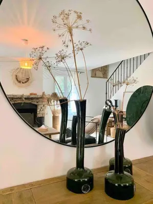 a tray with a bottle and glasses on a table at Villa Piscine Vue exceptionnelle in Murs