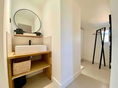a bathroom with a sink and a mirror at Villa Piscine Vue exceptionnelle in Murs