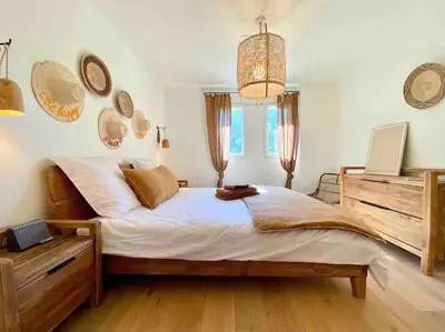 a bedroom with a bed with a bag on it at Villa Piscine Vue exceptionnelle in Murs