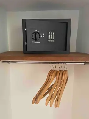 a shelf with wooden utensils next to a microwave at Maison de village in Pernes-les-Fontaines