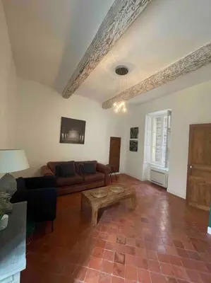 a living room with a couch and a coffee table at Maison de village in Pernes-les-Fontaines