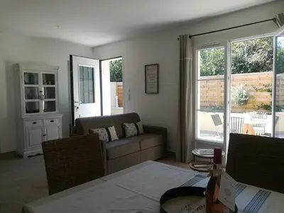 a living room with a couch and two windows at Le Mazet d'Olivia, escapade romantique en Provence in Châteauneuf-de-Gadagne