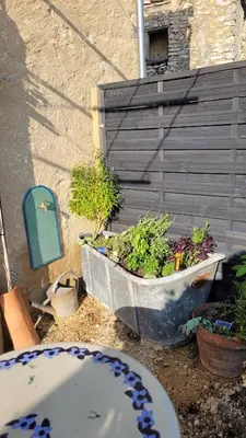 a planter with plants in it next to a fence at Maison de charme avec piscine in Simiane-la-Rotonde