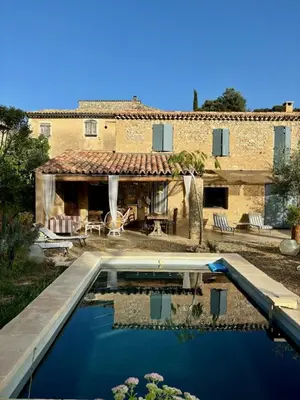 a house with a swimming pool in front of a house at Maison de charme avec piscine in Simiane-la-Rotonde