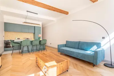 a living room with a blue couch and a table at Magnifique appartement centre historique in Aix-en-Provence