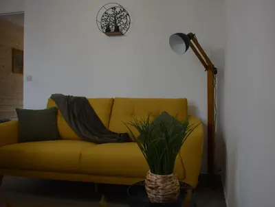 a yellow couch in a living room with a lamp at Villa ELISABETH in Aix-en-Provence