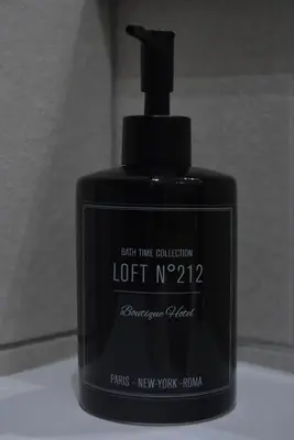a black bottle of lotion sitting on a table at Villa ELISABETH in Aix-en-Provence