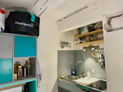 a small kitchen with blue cabinets and a sink at Studio cosy hypercentre Aix in Aix-en-Provence