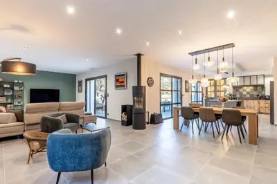 a living room with a table and chairs and a couch at Villa Feijoa en Provence in Velleron