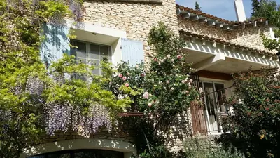 a brick house with flowers on the side of it at Charm in Provence in Saumane-de-Vaucluse