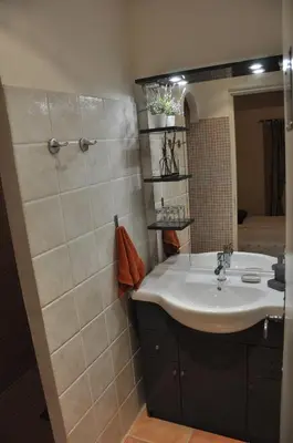 a bathroom with a sink and a mirror at Mas Clement - Chambre et table d'hôtes in LʼIsle-sur-la-Sorgue