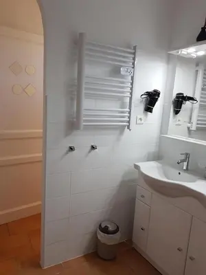 a white bathroom with a sink and a mirror at Mas Clement - Chambre et table d'hôtes in LʼIsle-sur-la-Sorgue