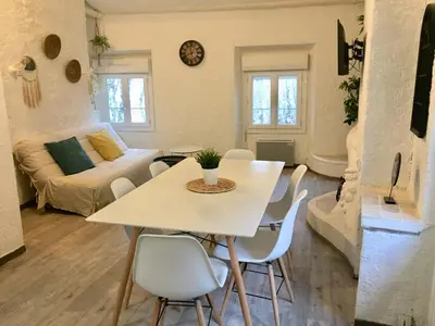 a living room with a table and chairs and a couch at Appartement Emil centre ville in Carpentras