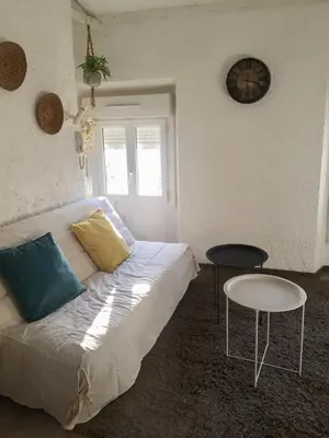 a living room with a couch and a table at Appartement Emil centre ville in Carpentras