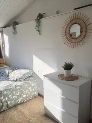 a bedroom with a bed and a mirror and a dresser at Appartement Emil centre ville in Carpentras