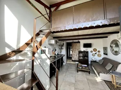a living room with a staircase and a living room at Appartement dans Mas Provencal in Grans