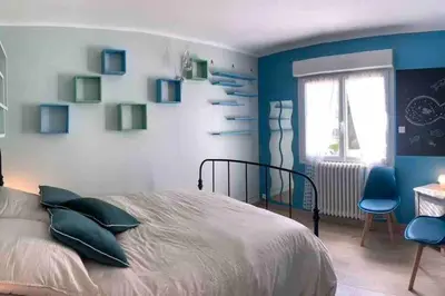 a kitchen with a wooden table with chairs and lights at Maison de ville spacieuse & cosy in LʼIsle-sur-la-Sorgue