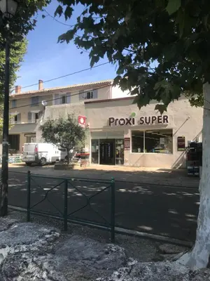 a store with a sign on the side of a street at Appartement climatisé au pied du Mont Ventoux in Malemort-du-Comtat