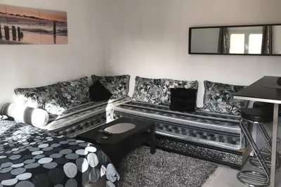 a living room with a couch and a mirror at Studios moderne et spacieux in Morières-lès-Avignon