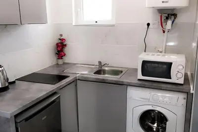 a kitchen with a sink and a washing machine at Studios moderne et spacieux in Morières-lès-Avignon