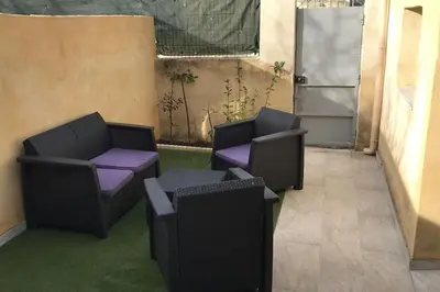 a patio with two chairs and purple cushioned chairs at Studios moderne et spacieux in Morières-lès-Avignon