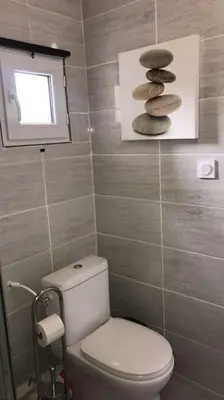 a bathroom with a toilet and a pile of rocks at Studios moderne et spacieux in Morières-lès-Avignon